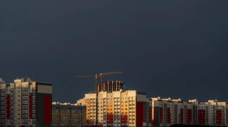 horizontal-shot-buildings-construction-site-cloudy-sky-sunset.webp