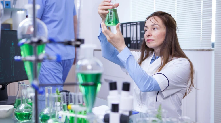 mature-female-scientist-making-scientific-test-her-research-lab-chemical-test-tubes-ijpvj-1vrsp.webp