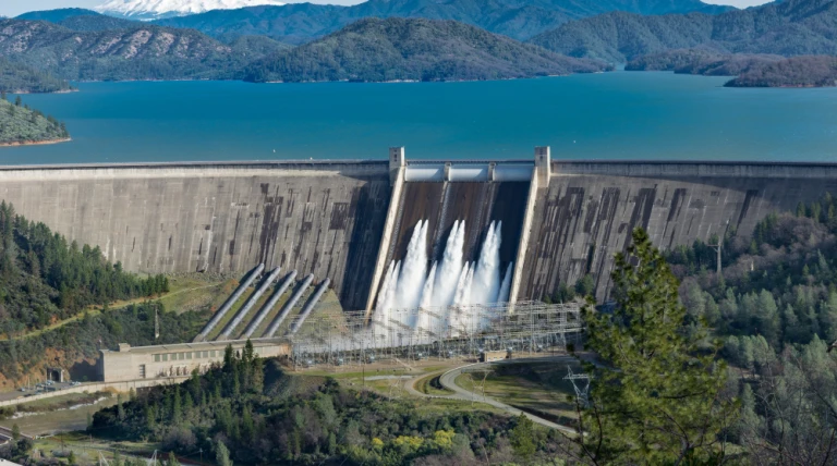 picture-shasta-dam-surrounded-by-roads-trees-with-lake-mountains-1.webp