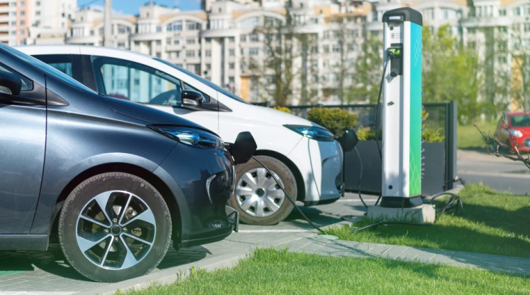 two-charging-electric-cars-charge-station-city.webp